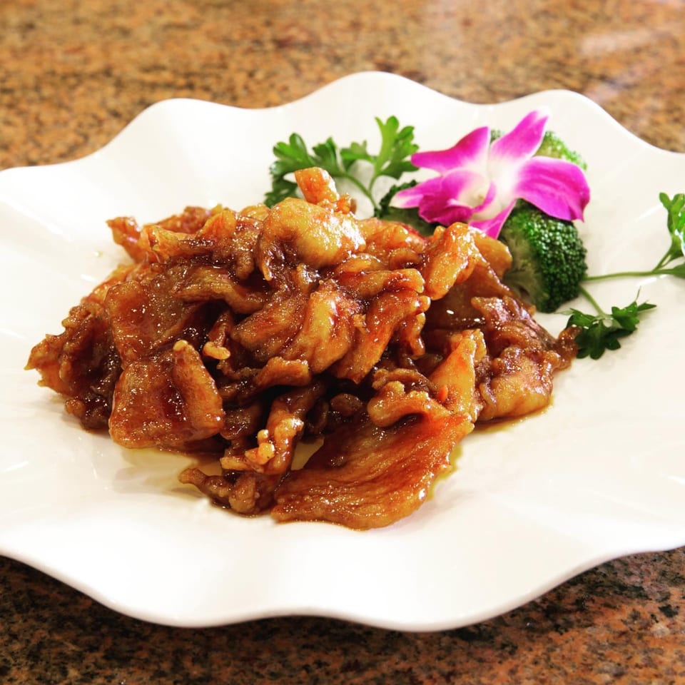 Monark Asian Bistro's sweet and sour pork, garnished with broccoli, parsley, and an orchid.
